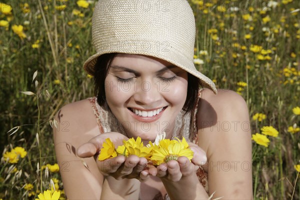 Caucasian woman picking wildflowers in field