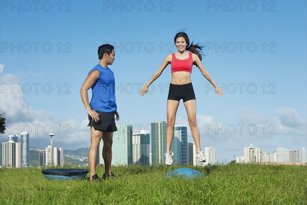 Couple exercising together in field