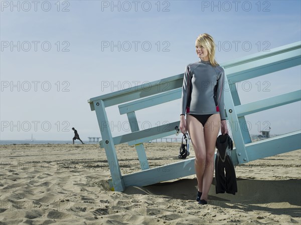 Caucasian lifeguard standing at lifeguard station