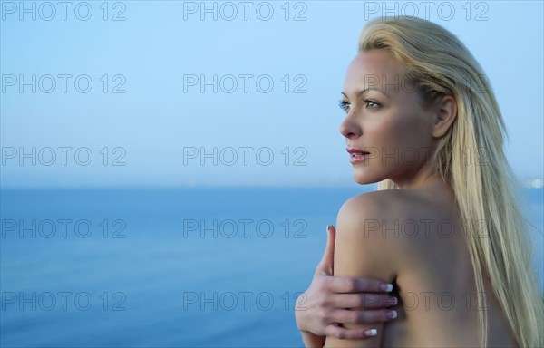 Caucasian woman standing near ocean