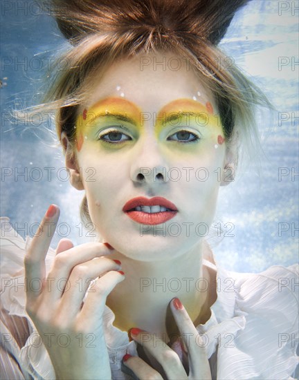 Caucasian woman swimming under water