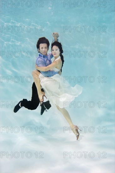 Couple dancing under water