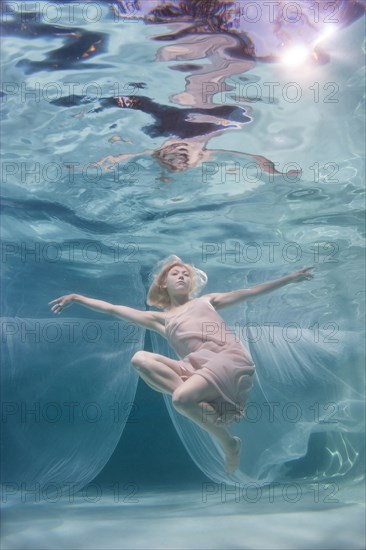 Caucasian woman posing in pool