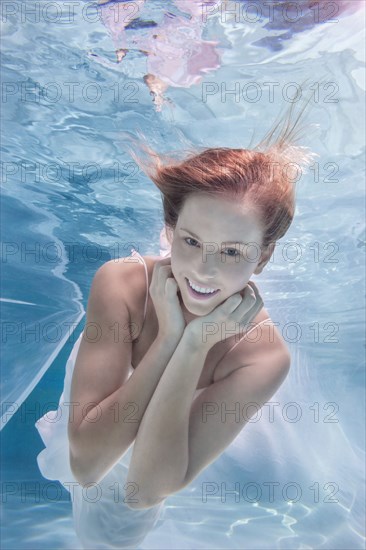 Caucasian woman posing in pool