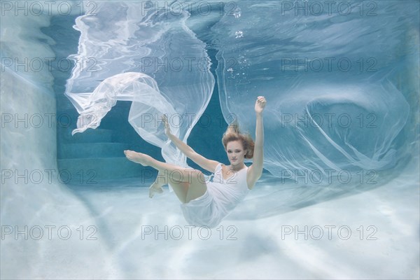 Caucasian woman posing in pool