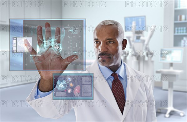 Black doctor looking at digital display in doctor's office