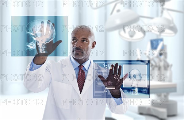 Black doctor looking at digital display in doctor's office