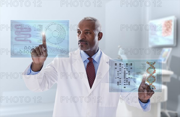 Black doctor looking at digital display in laboratory