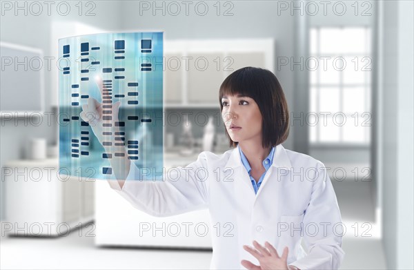 Mixed race doctor using digital display in a lab