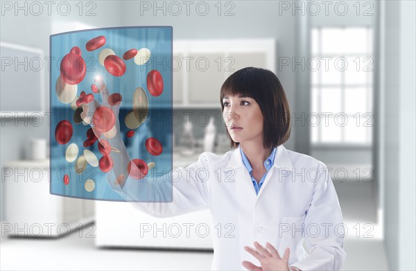Mixed race doctor using digital display in doctor's office