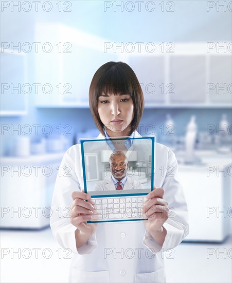 Mixed race doctor using digital tablet in a lab