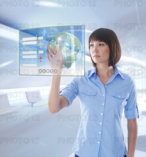 Mixed race businesswoman using digital display