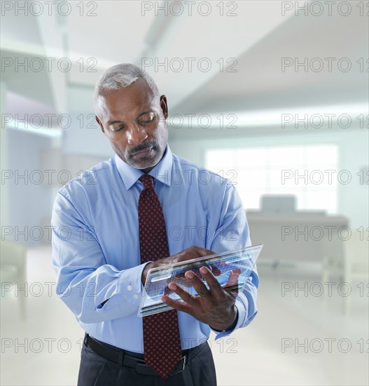Black businessman using digital tablet in a lab