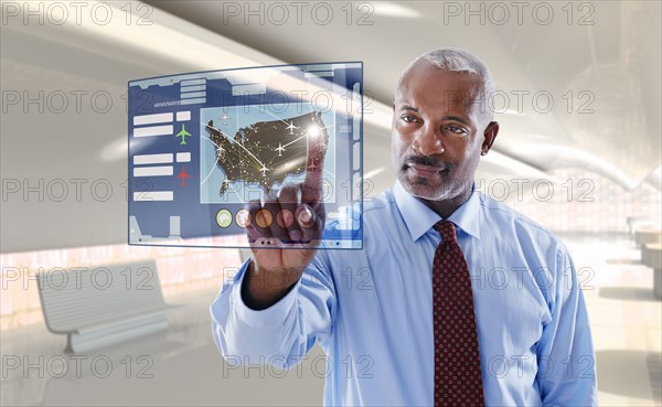 Black businessman using digital display