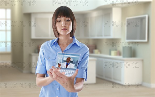 Mixed race woman using digital tablet in office