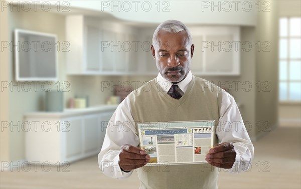 Black businessman using digital tablet in office