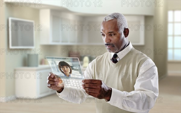 Black businessman using digital tablet in office