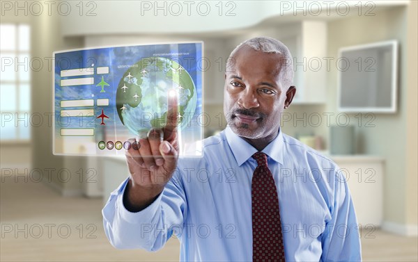 Black businessman using digital display in office