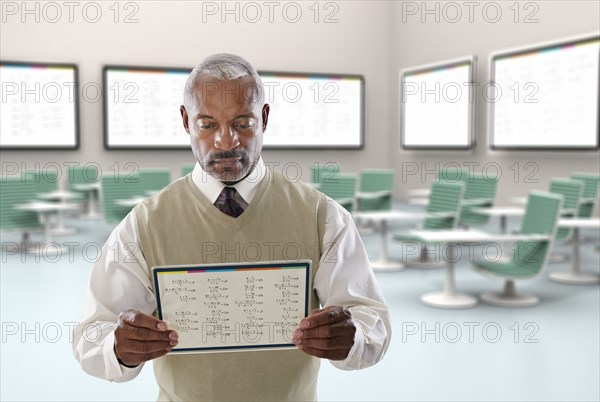 Black businessman using digital tablet in conference room