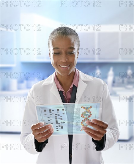 Black doctor using digital tablet in doctor's office