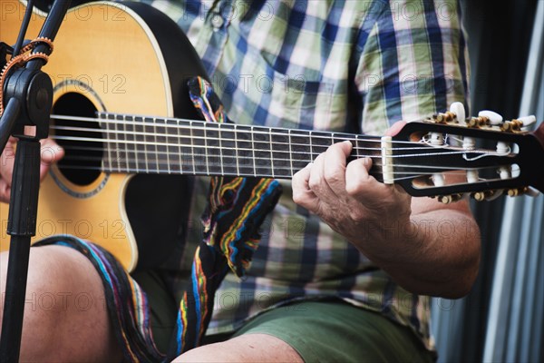 Man sitting and playing guitar