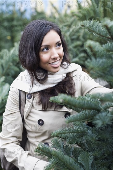 Middle Eastern woman looking at pine trees