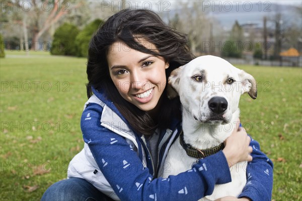 Middle Eastern woman hugging dog