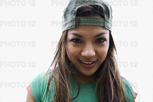 Asian woman posing in backwards cap