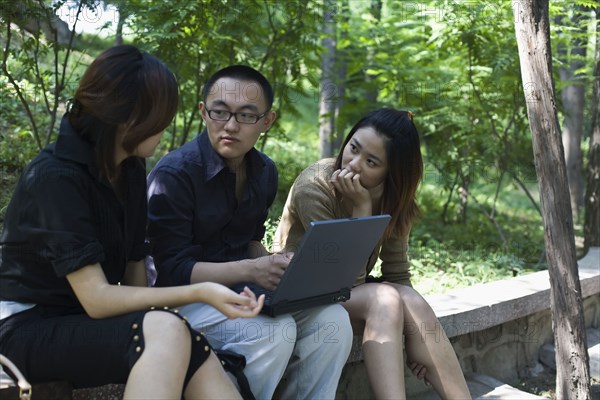 Chinese businesspeople working in park