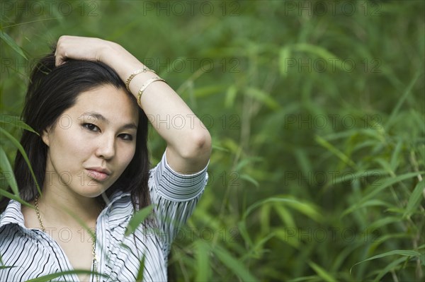 Japanese woman outdoors with head in hands