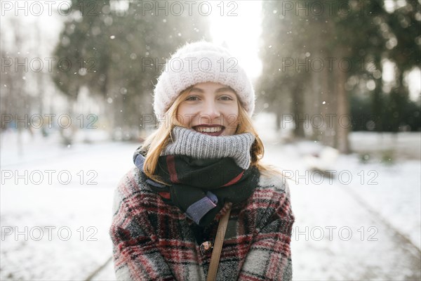 Caucasian woman smiling in snow