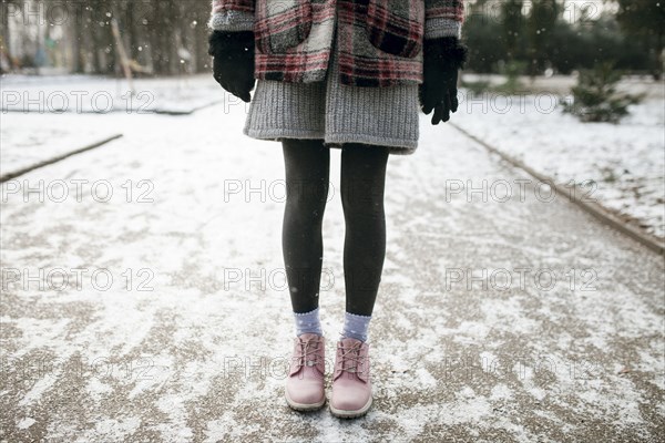 Legs of Caucasian woman standing in snow