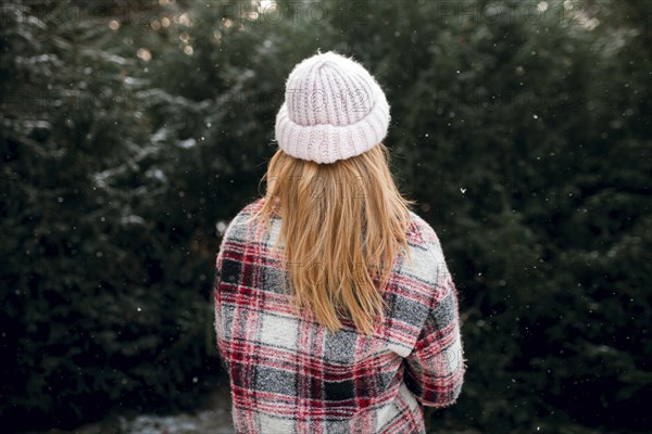 Rear view of Caucasian woman near trees in snow