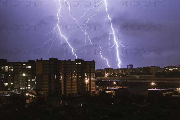 Lightning striking city at night