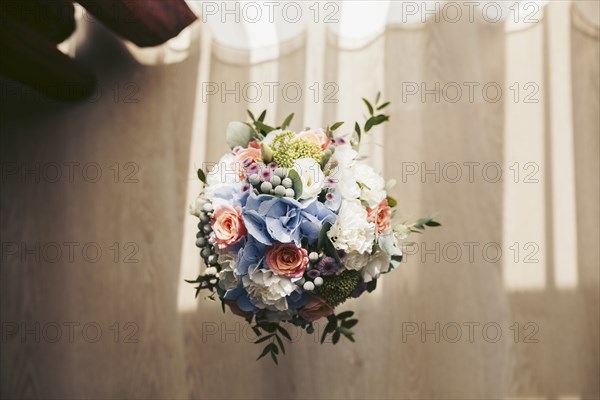 Bouquet of flowers in vase on floor