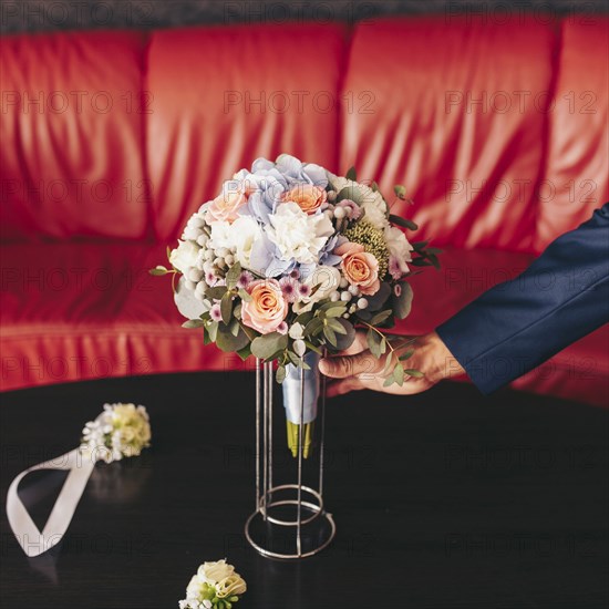 Caucasian man placing bouquet of flowers on table