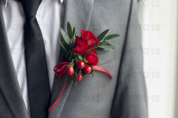Red corsage on suit jacket