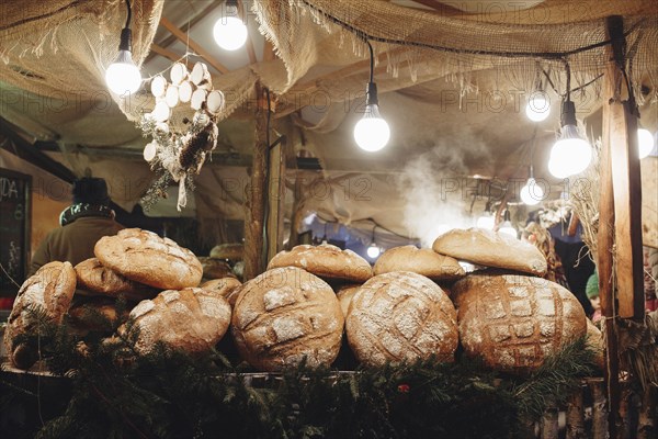 Pile of loaves of bread on table in tent