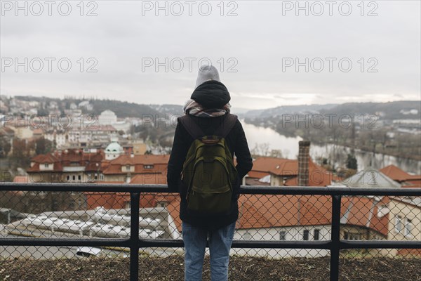 Caucasian woman wearing backpack admiring scenic view of city