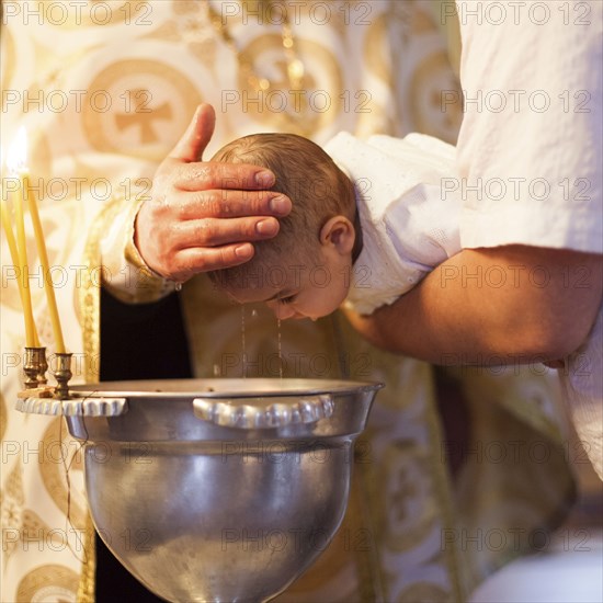 Caucasian baby girl being baptized