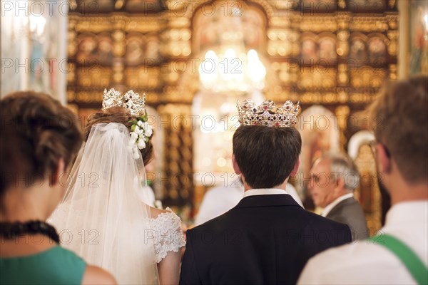 Couple wearing crowns in church