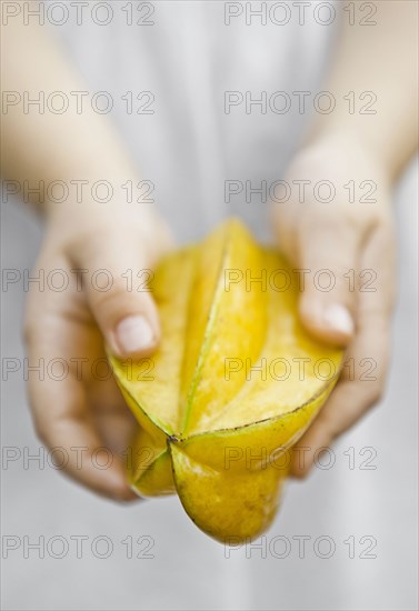 Caucasian child holding fruit