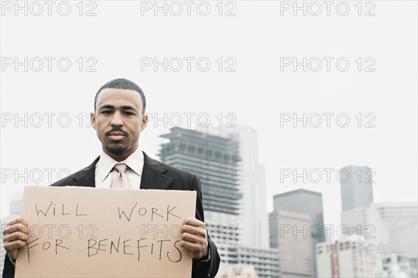 Businessman holding a sign proclaiming