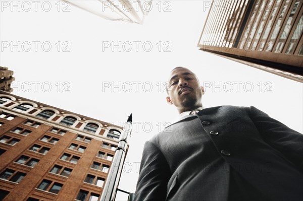 Low angle view of businessman in urban setting