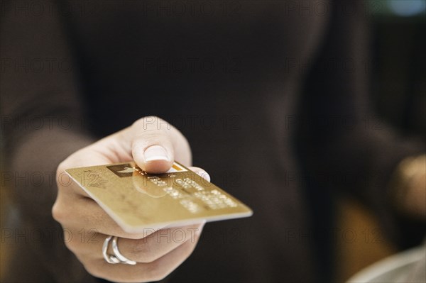 Young woman paying with a credit card