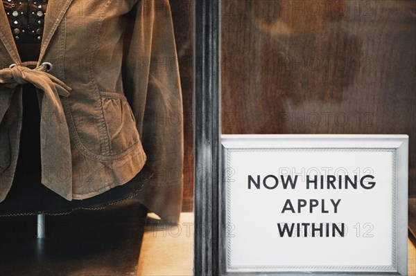 Now Hiring sign in store window