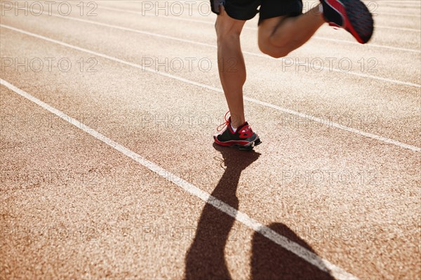 Male athlete running on a track