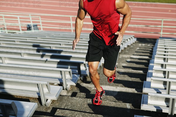 Male athlete running up steps