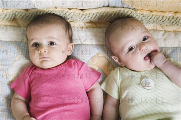 Portrait of two babies on blanket