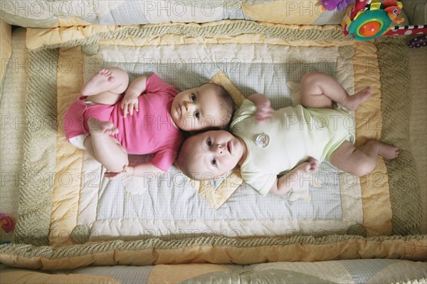 High angle view of two babies on blanket